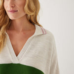 closeup of woman showcasing mersea marina polo sweater in green and sea salt stripe