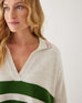 closeup of woman showcasing mersea marina polo sweater in green and sea salt stripe
