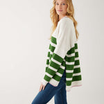 profile of woman showcasing mersea marina polo sweater in green and sea salt stripe