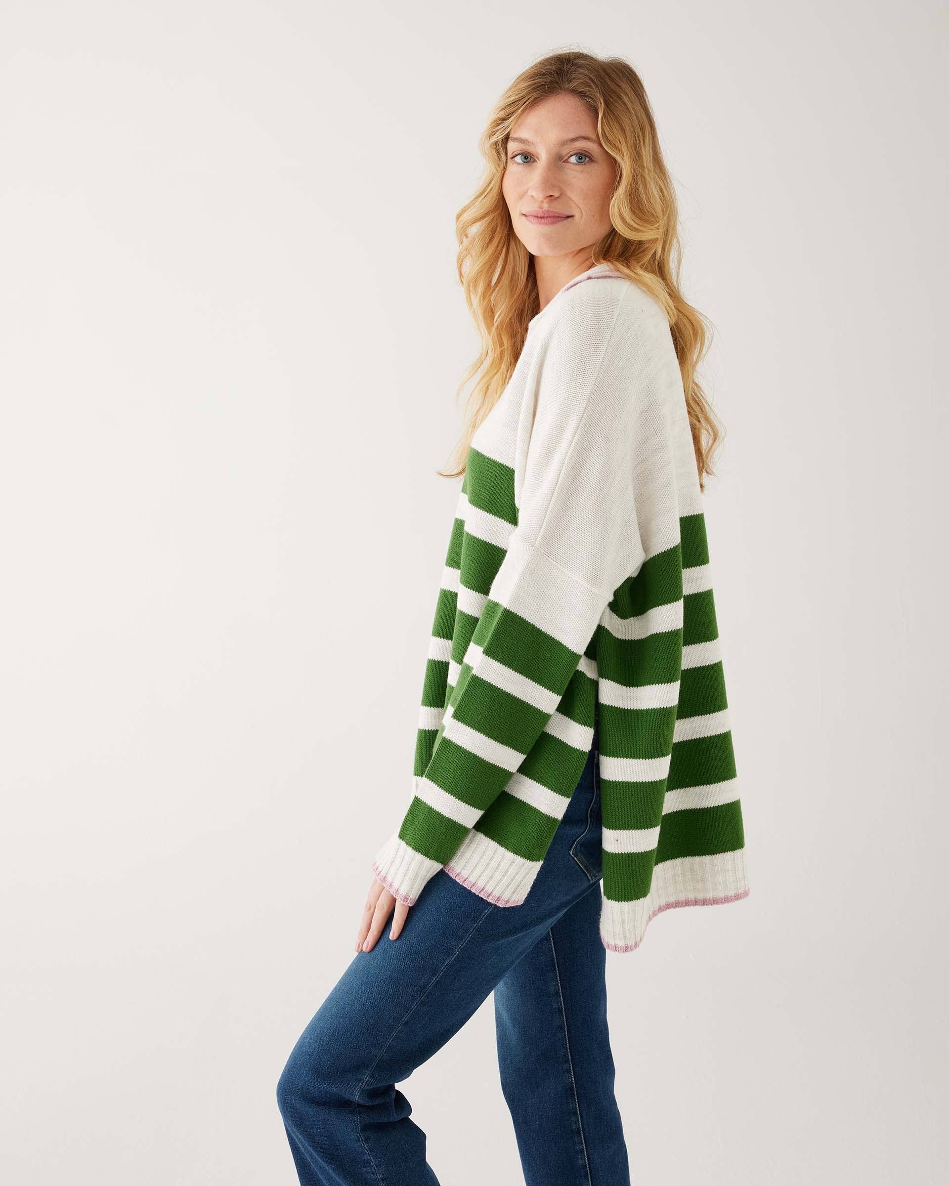 profile of woman showcasing mersea marina polo sweater in green and sea salt stripe