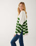profile of woman showcasing mersea marina polo sweater in green and sea salt stripe