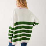 rearview of woman showcasing mersea marina polo sweater in green and sea salt stripe