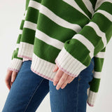 woman showcasing mersea marina polo sweater in green and sea salt strip