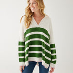 woman showcasing mersea marina polo sweater in green and sea salt stripe