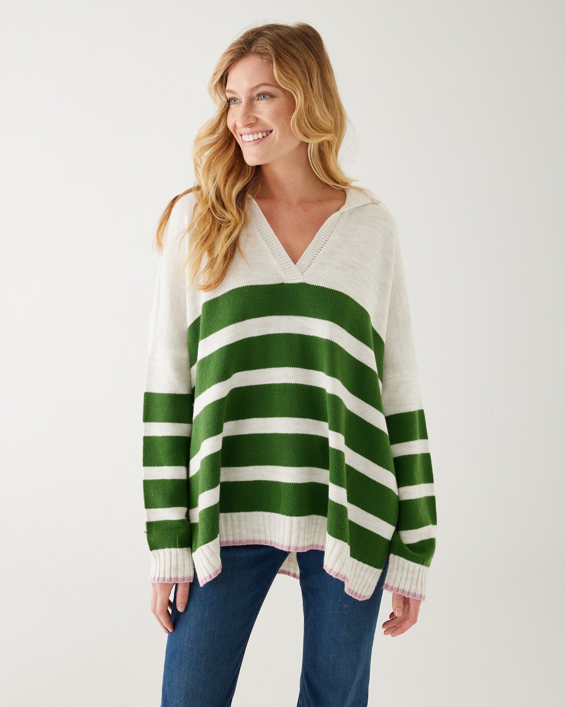 woman showcasing mersea marina polo sweater in green and sea salt stripe