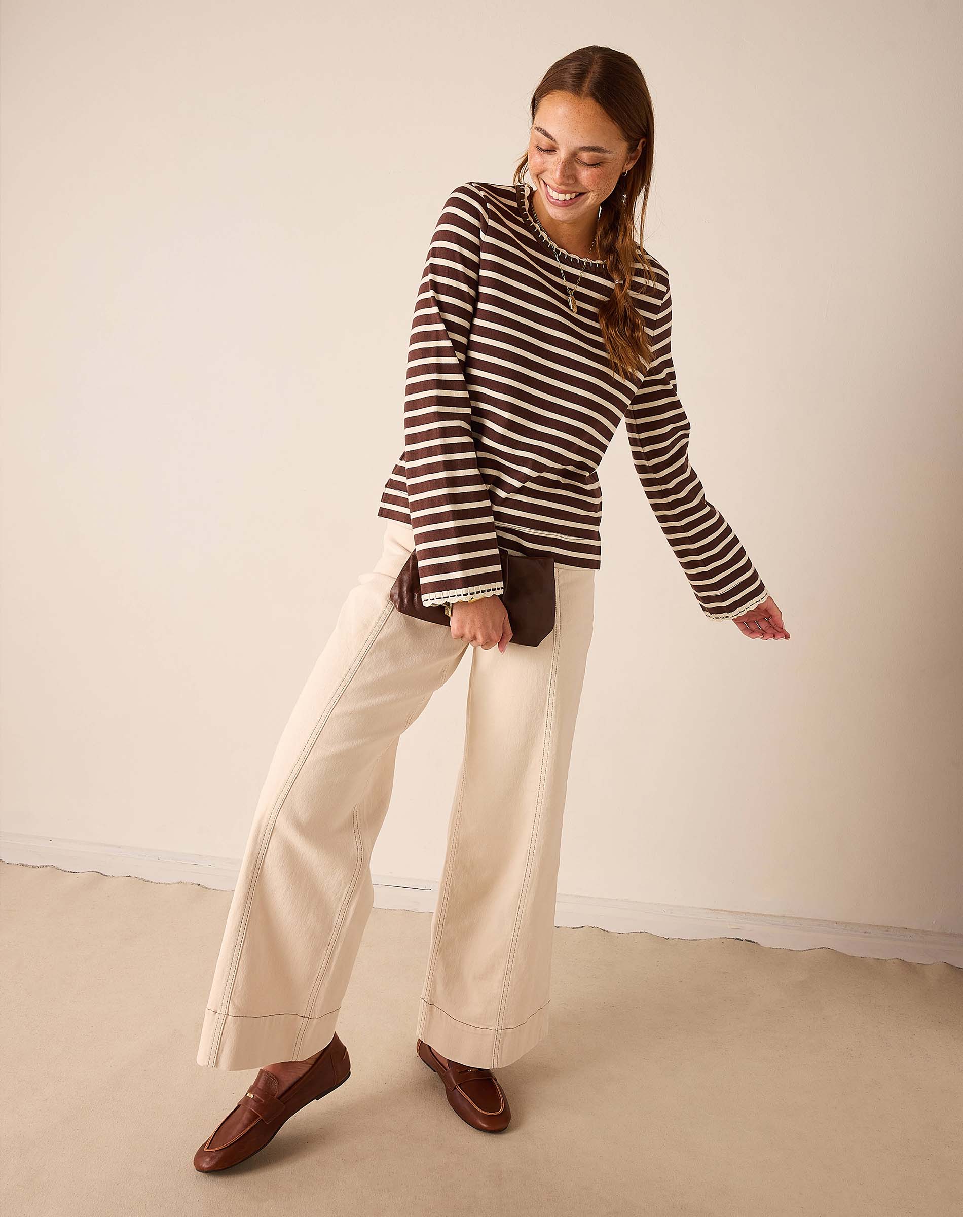 Women's travel-friendly espresso and creme striped long sleeve tee with a relaxed fit.