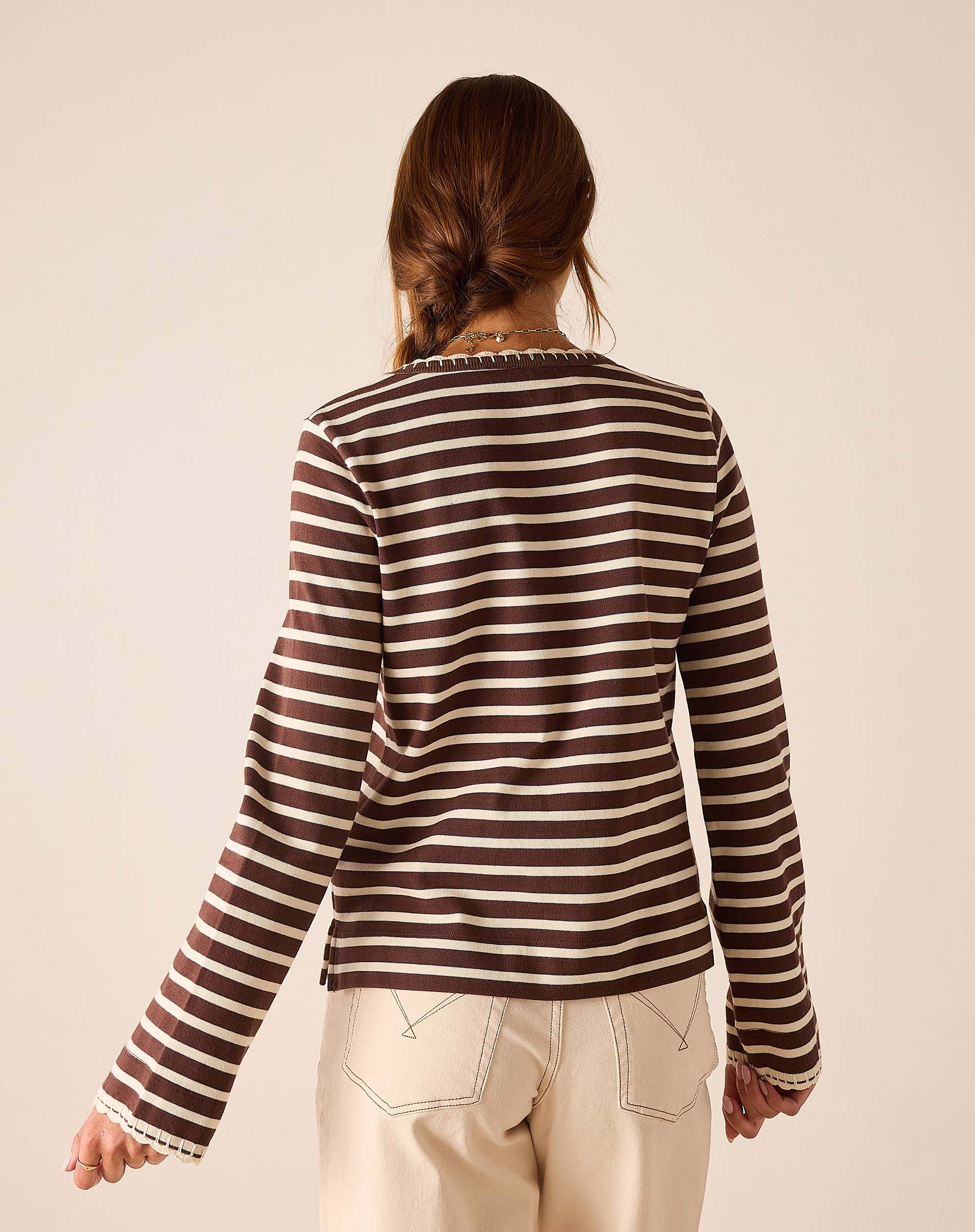 Back view of a espresso and creme striped crewneck tee.