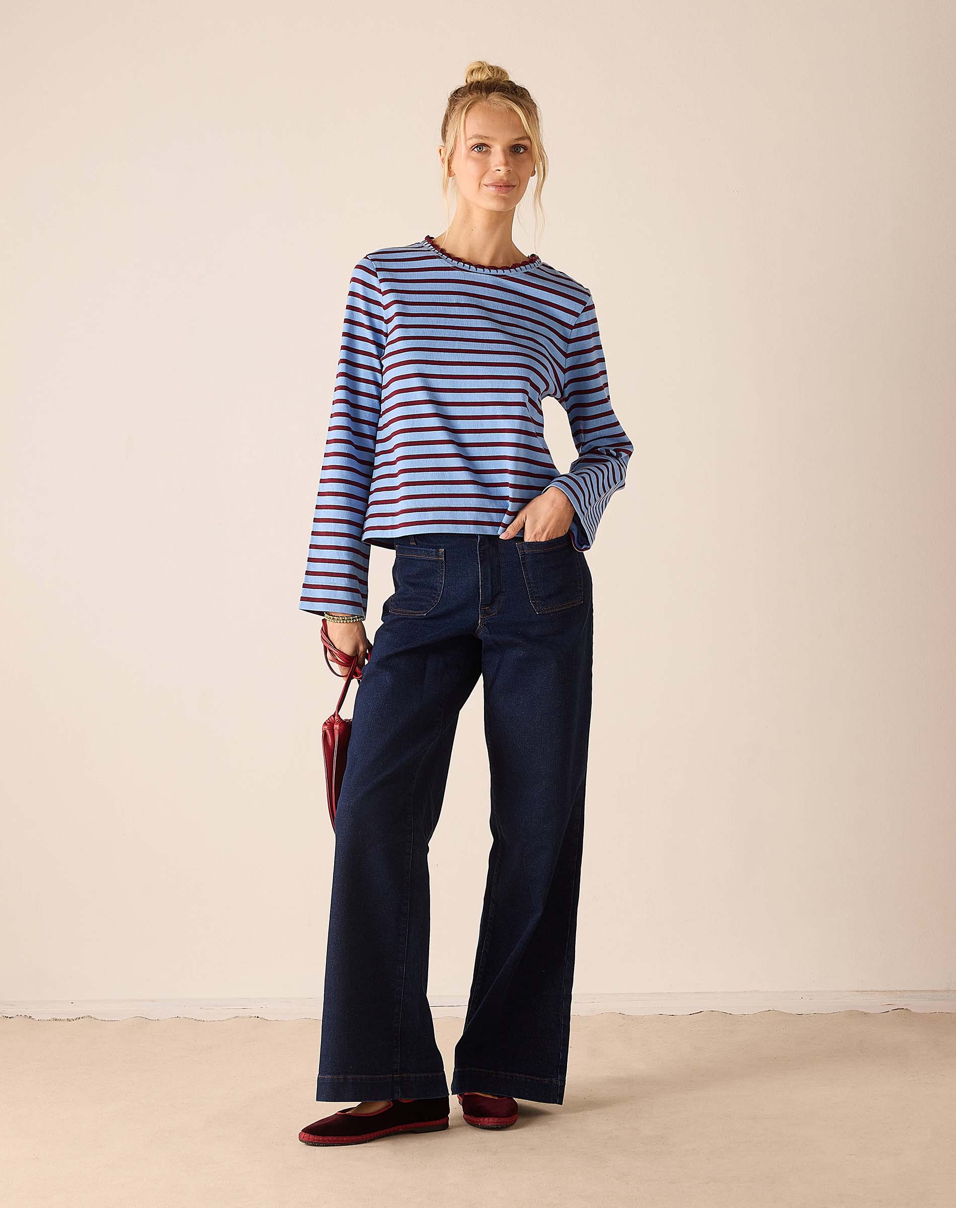 Women's travel-friendly plum and berry striped crewneck tee made of soft knit fabric.