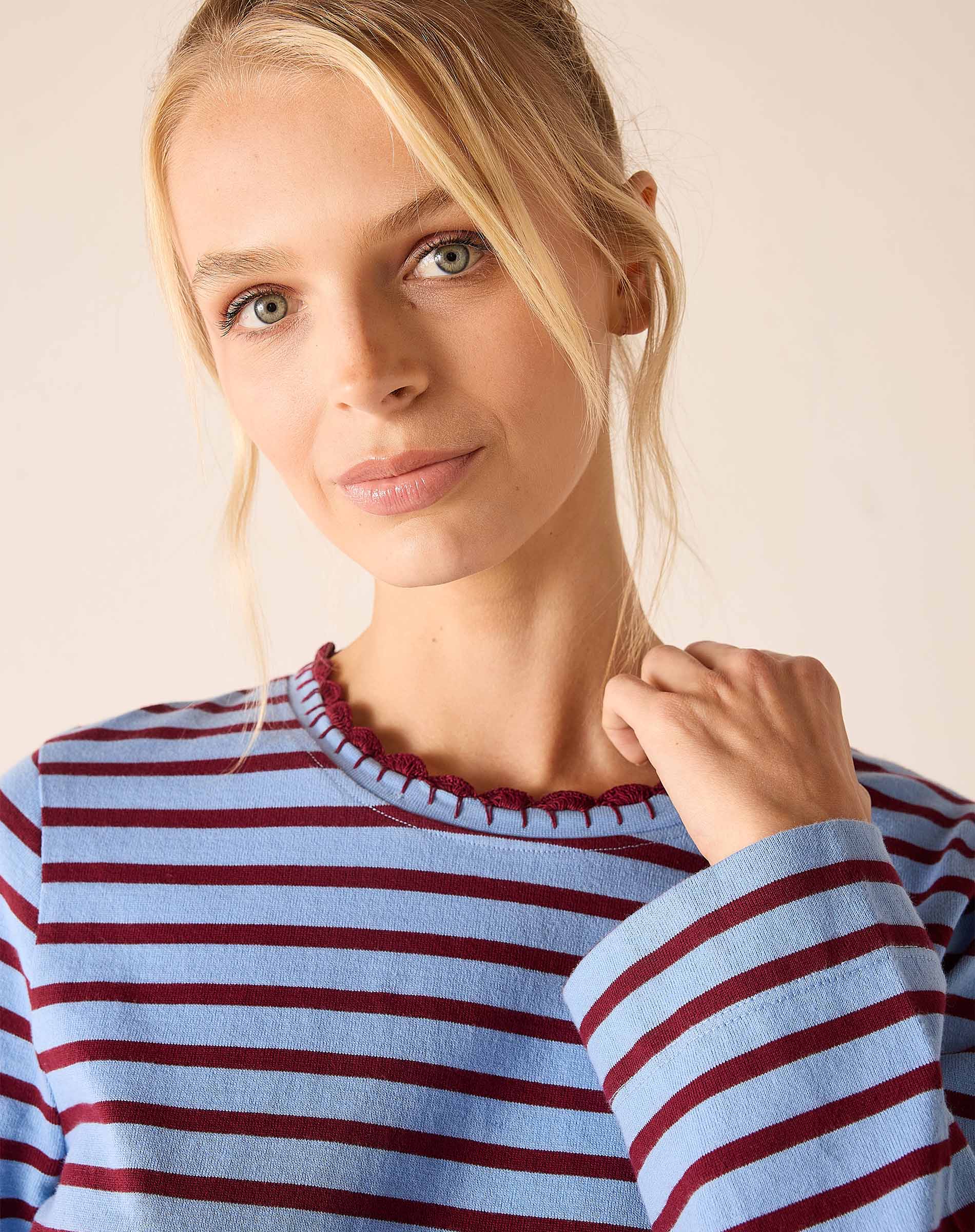 Plum and berry striped knit tee with a ruffled neckline.