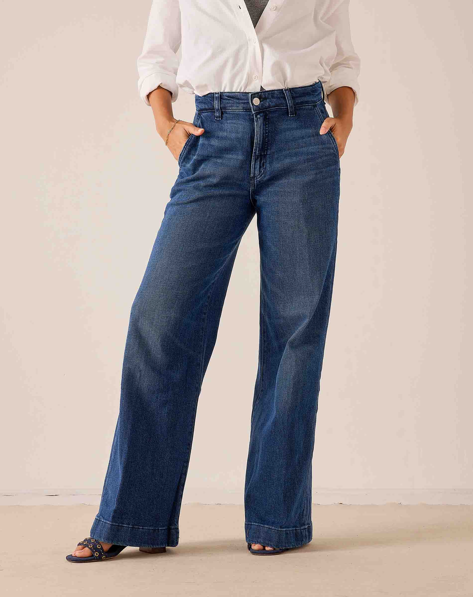 Deep indigo blue wide-leg denim trousers featuring a relaxed fit and subtle fading.