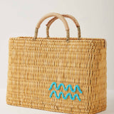 Market straw basket with tan leather handles and Aquarius symbol embroidered in light blue