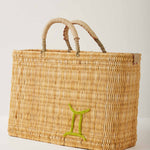 Market straw basket with tan leather handles and Gemini symbol embroidered in green