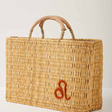 Market straw basket with tan leather handles and Leo symbol embroidered in burnt orange