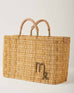 Market straw basket with tan leather handles and Virgo symbol embroidered in brown