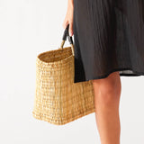 woman holding medina tassel basket