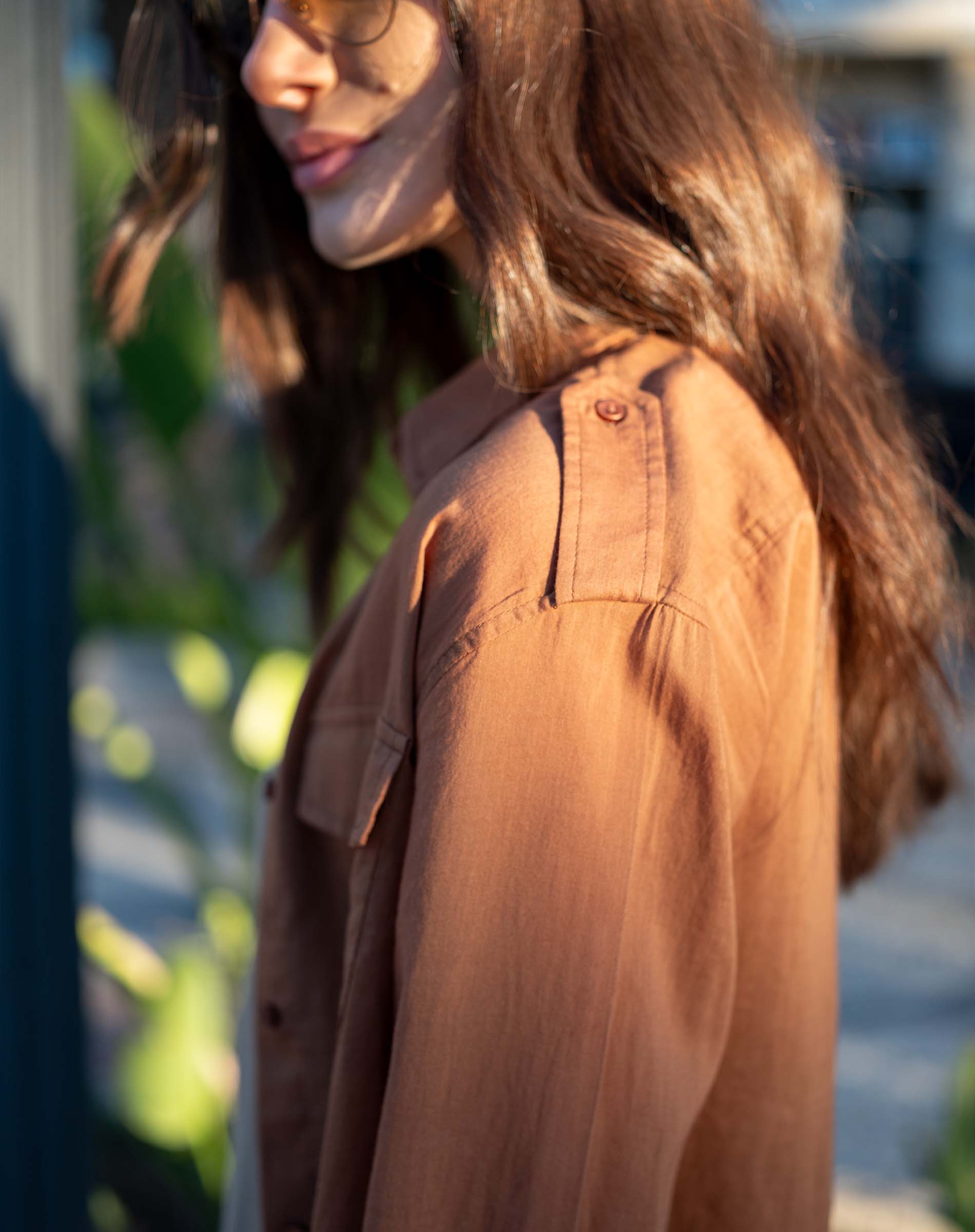 Saddle brown cotton button-up shirt featuring double pockets and a relaxed fit.
