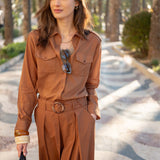 Saddle brown button-front linen shirt with double front pockets and cuffed sleeves.