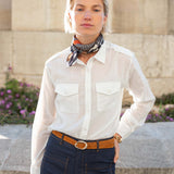 Ladies' travel-ready white button-down shirt with double chest pockets and a linen fabric feel.