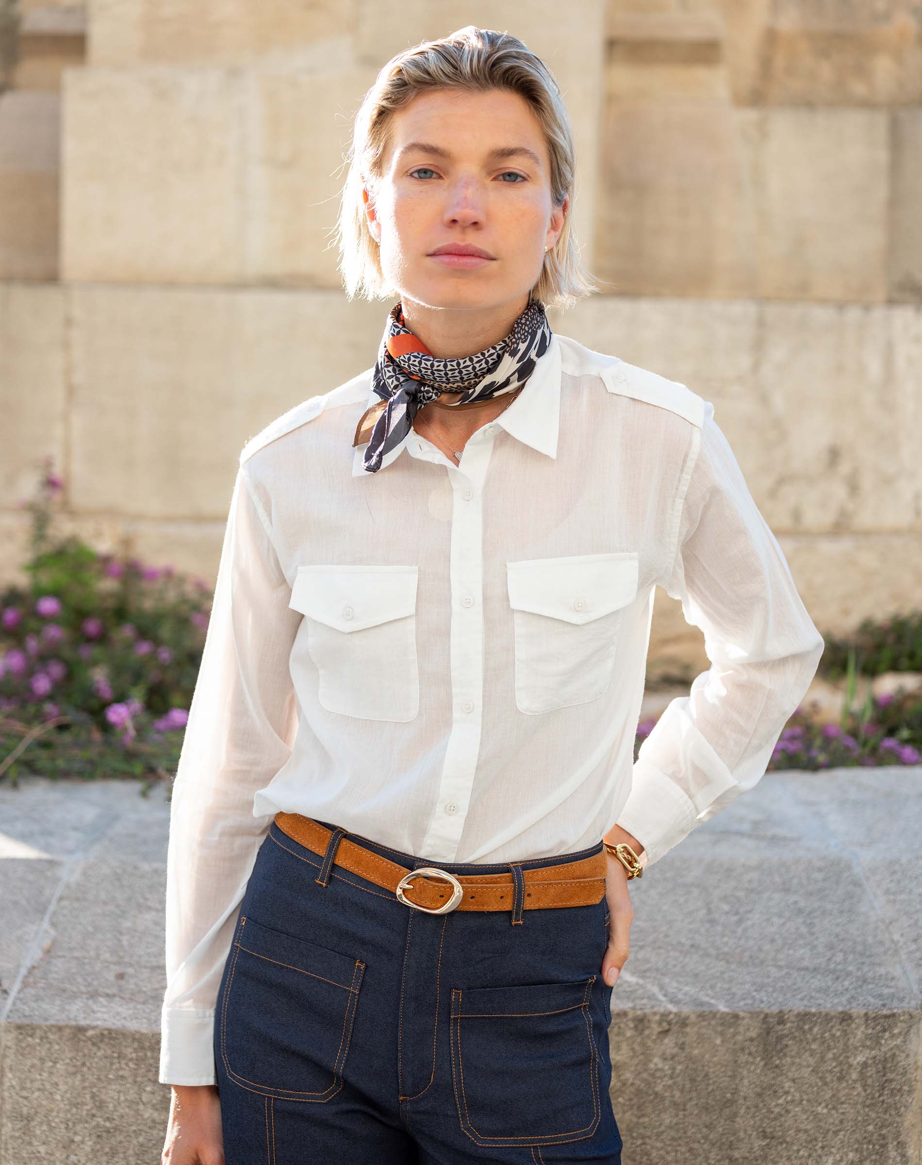 Ladies' travel-ready white button-down shirt with double chest pockets and a linen fabric feel.