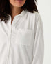 closeup of woman showcasing white mersea modern oxford tee button down