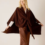 Chocolate brown knit travel wrap with an oversized front knot and a textured weave.