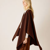 Side view of the chocolate-colored knit travel wrap with a draped silhouette.