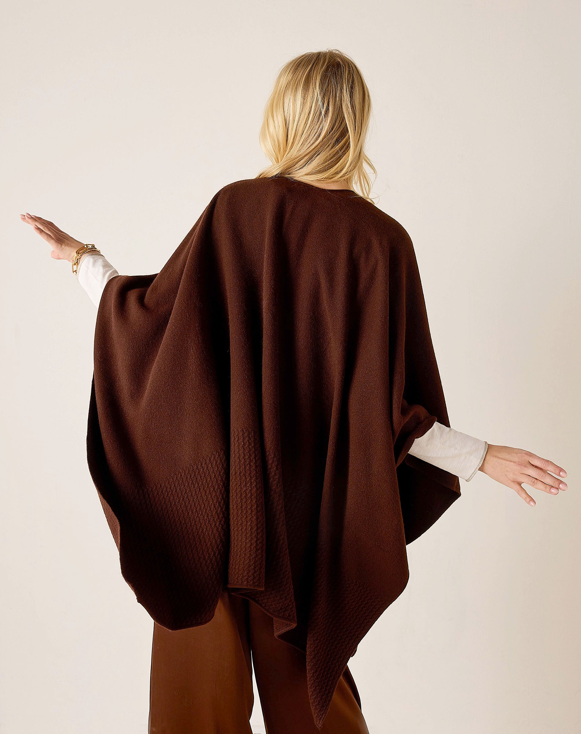 Back view of the chocolate brown textured knit travel wrap.