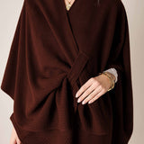 Chocolate brown knit travel wrap with a wide draped front and soft textured finish.