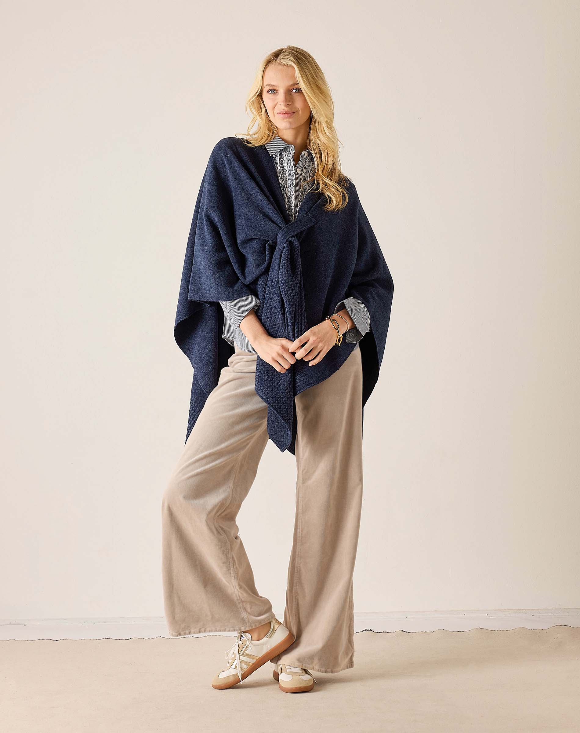 Navy blue travel wrap in a chunky knit texture with a draped front.