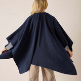 Back view of the navy textured travel wrap with wide sleeves.
