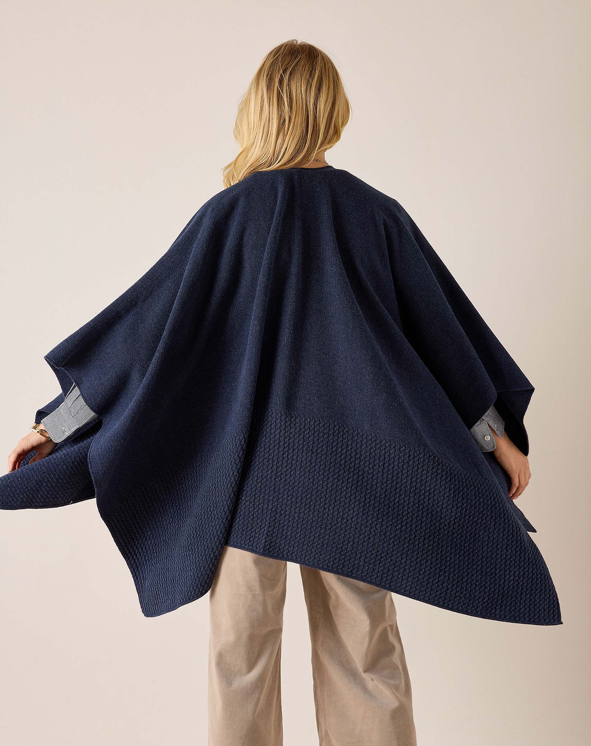 Back view of the navy textured travel wrap with wide sleeves.