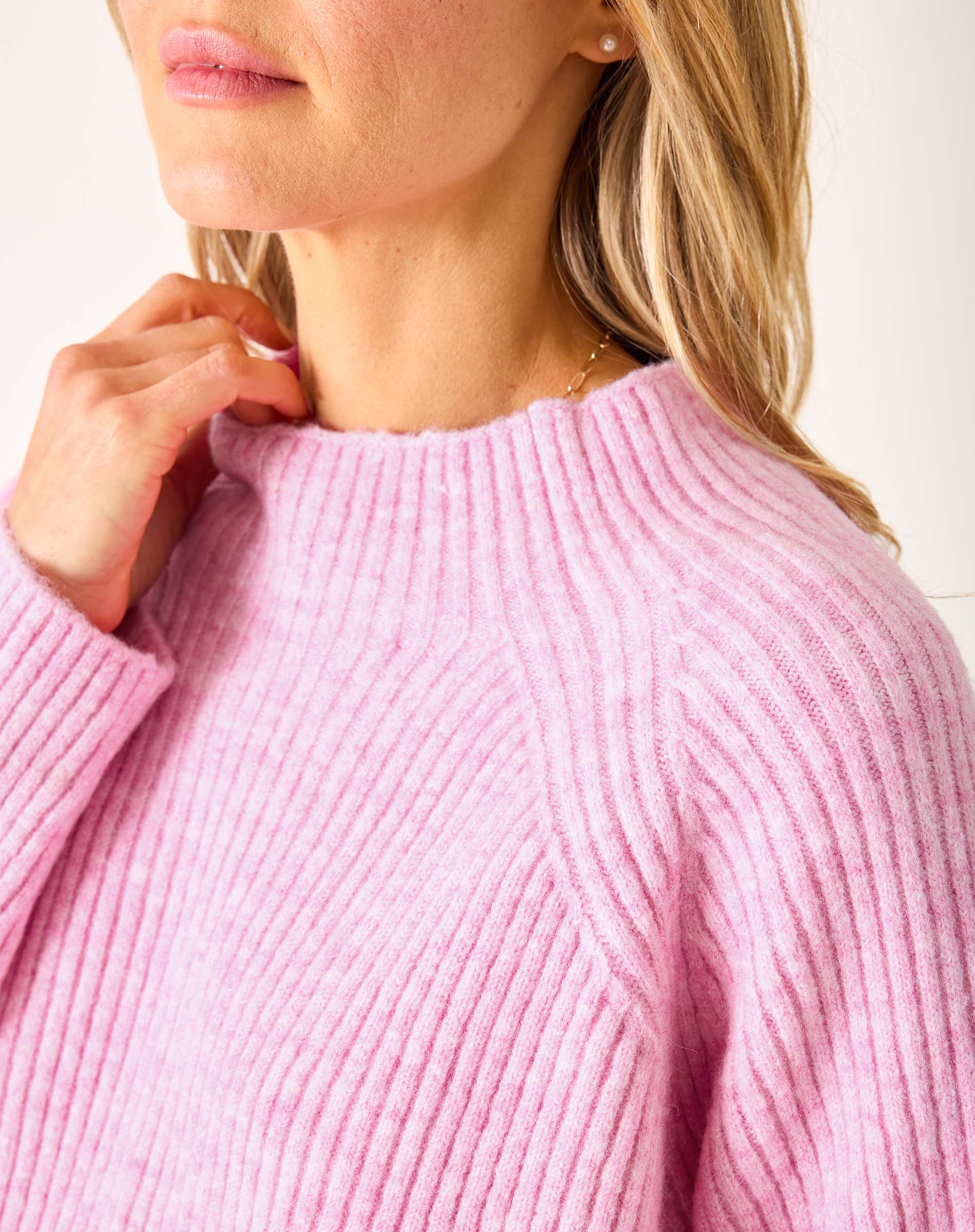 Heathered dewy pink mockneck knit sweater with a ribbed neckline and wide-ribbed body.