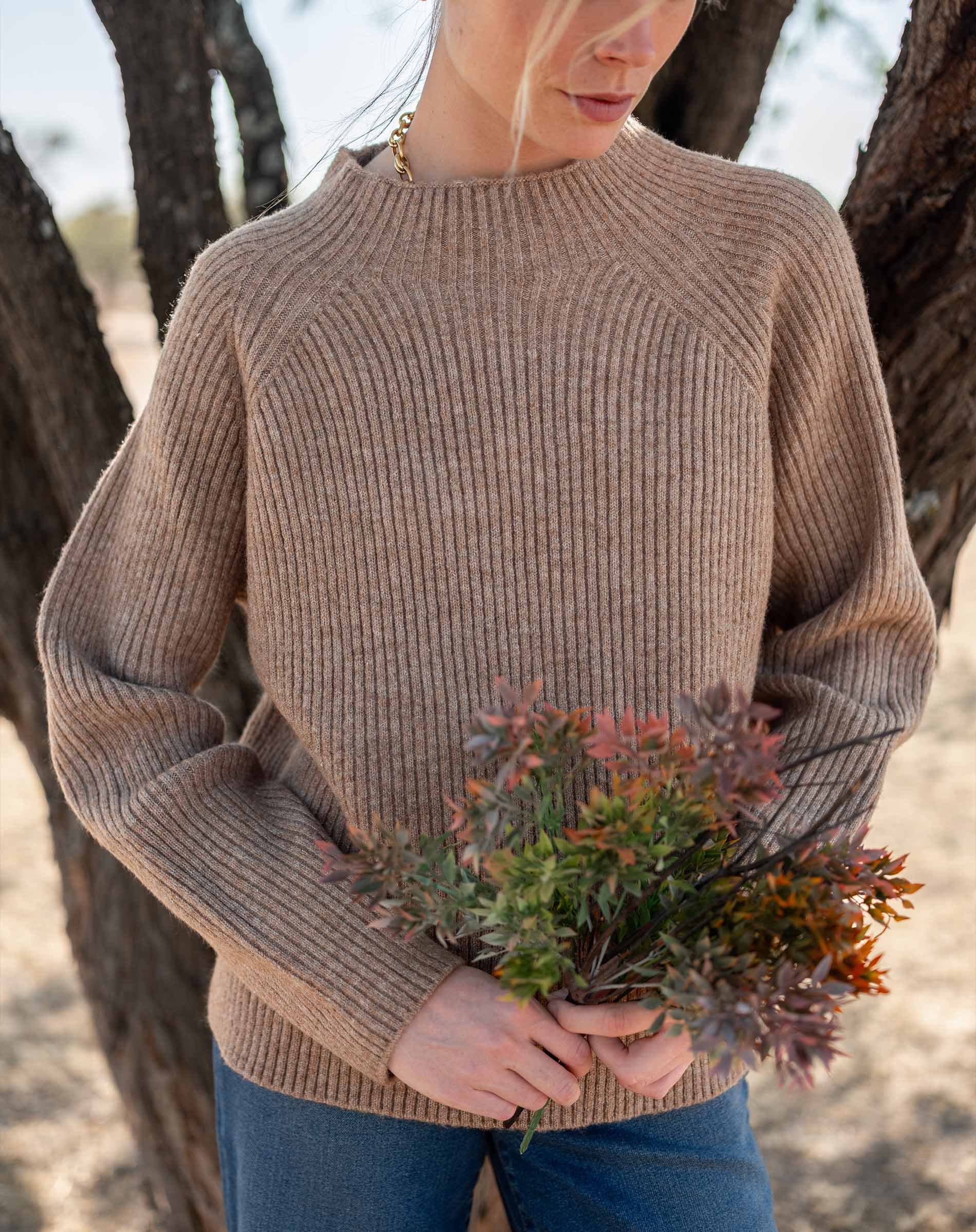 Heathered driftwood mockneck sweater in a ribbed knit.