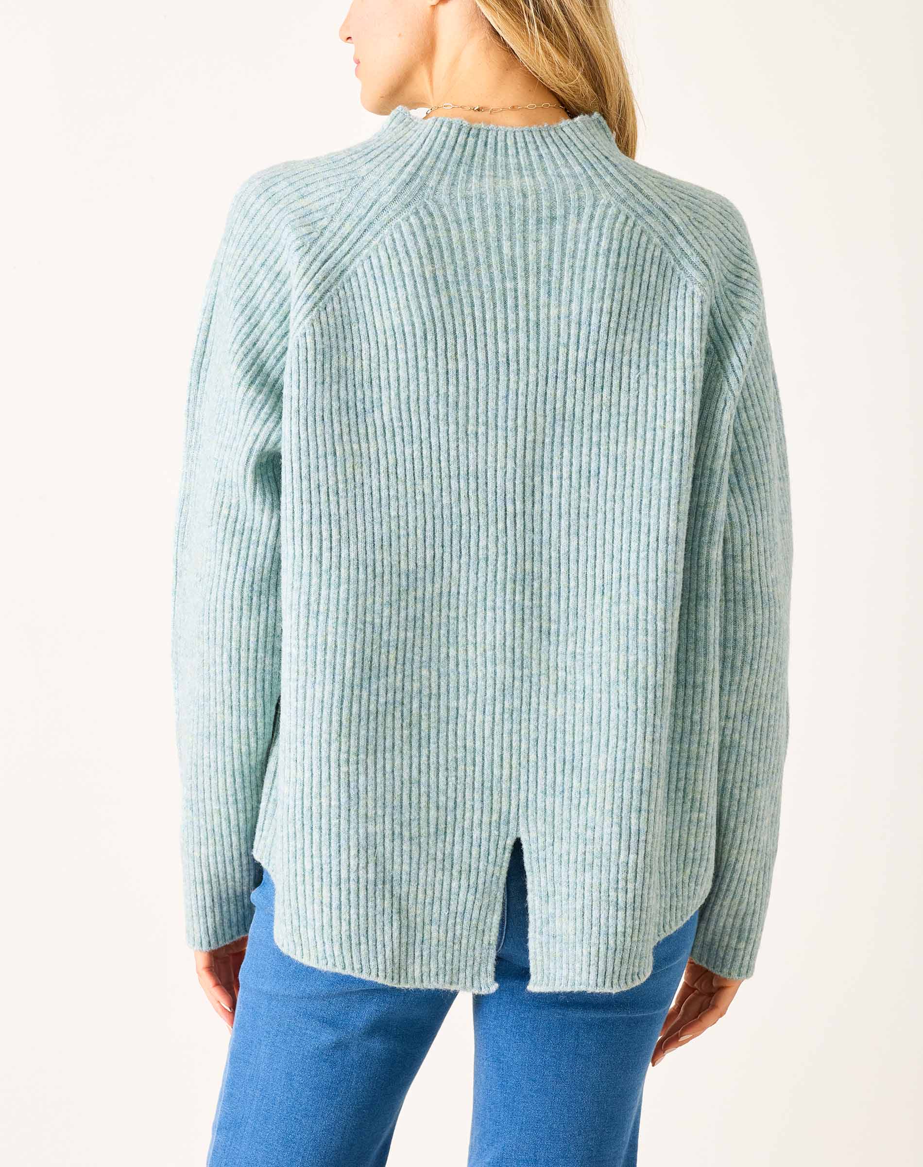 Heathered sea foam mockneck sweater with a ribbed texture and split back hem.