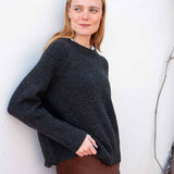 Graphite ribbed knit sweater with a wide boat neck and dropped shoulders.