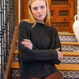 Graphite ribbed knit sweater with long sleeves and a rounded neckline.