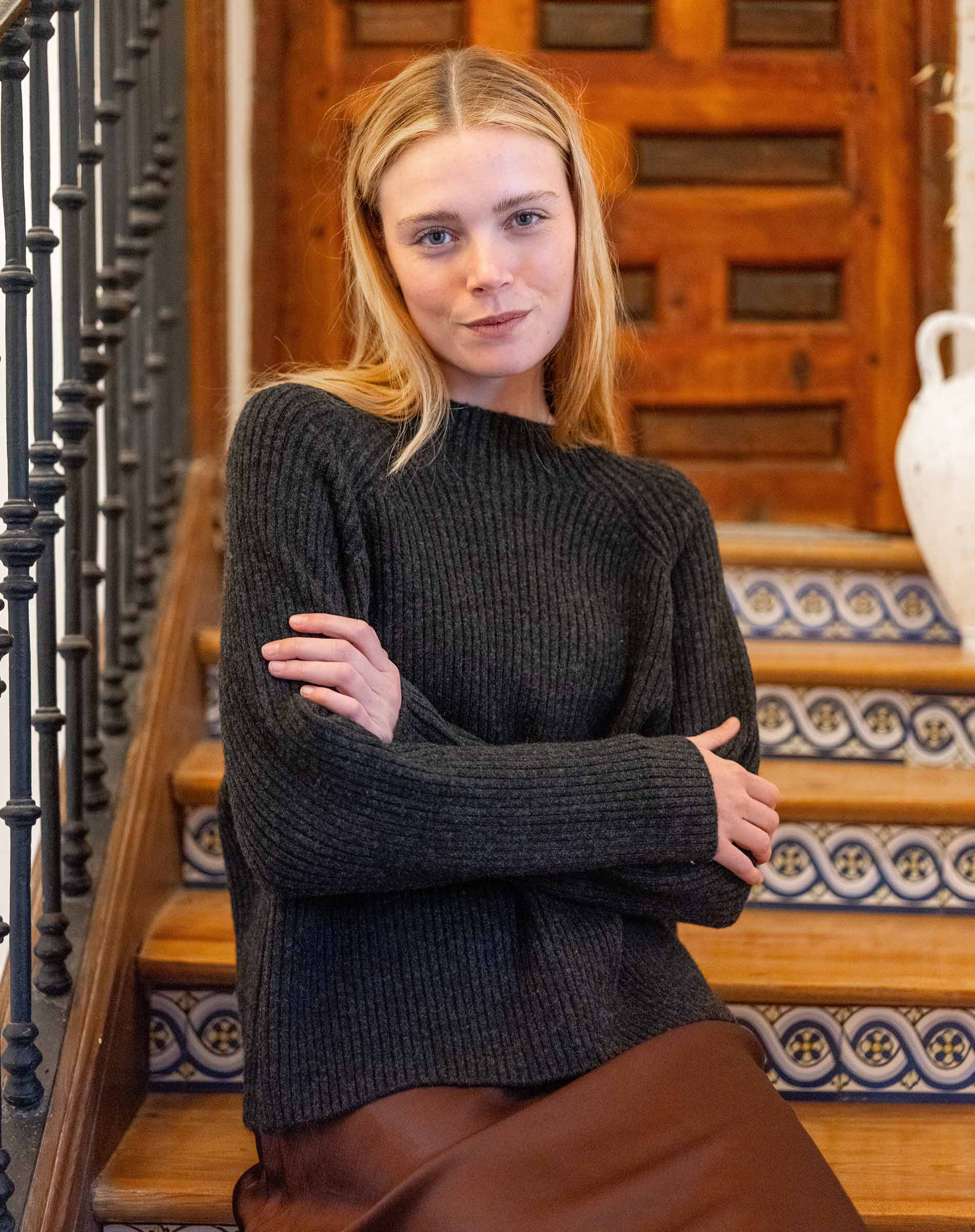 Graphite ribbed knit sweater with long sleeves and a rounded neckline.
