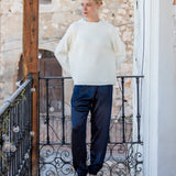Ladies' travel-ready winter white ribbed knit sweater with oversized fit and drop shoulders.