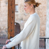 Winter white ribbed knit sweater with a relaxed fit and long sleeves.