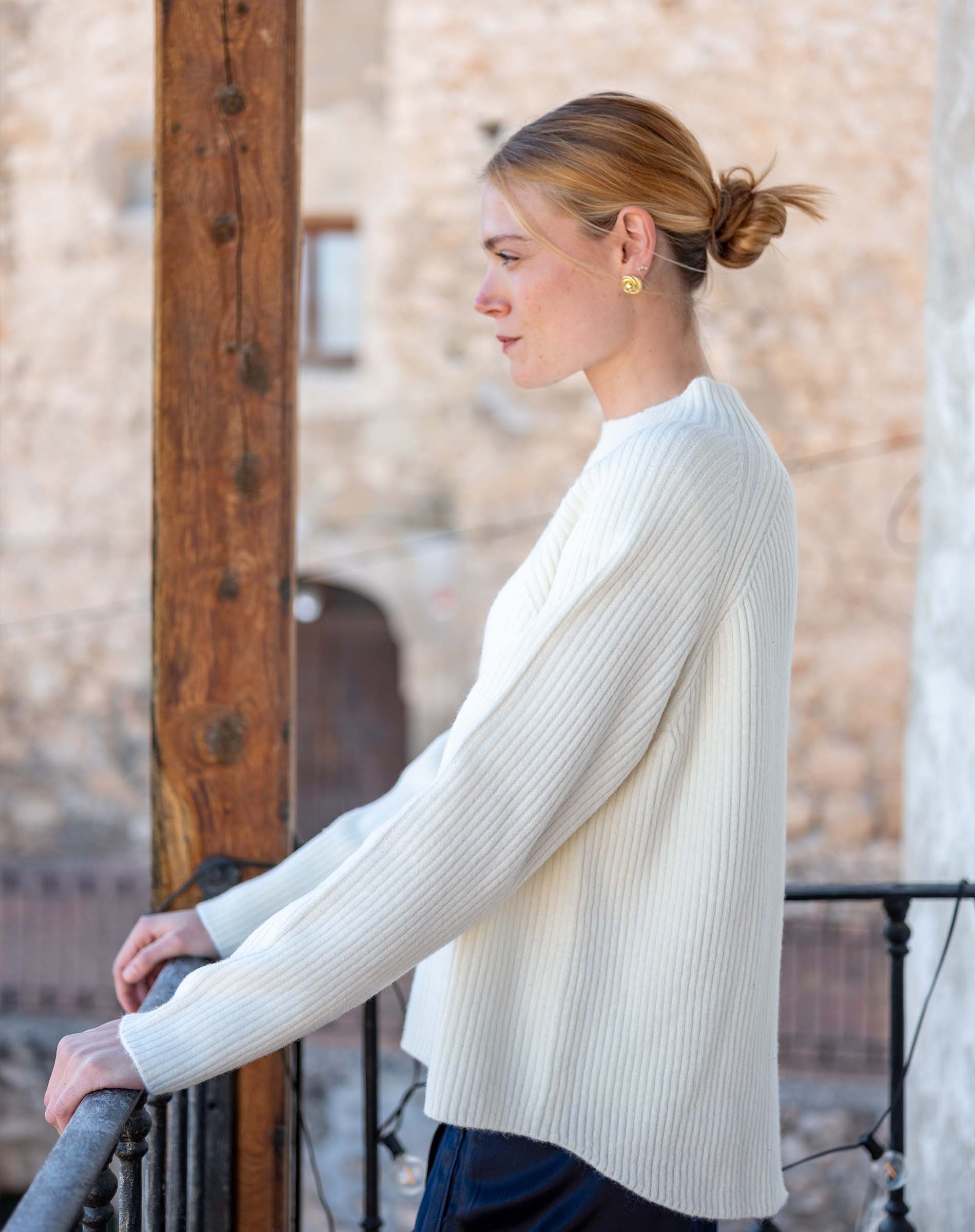 Winter white ribbed knit sweater with a relaxed fit and long sleeves.