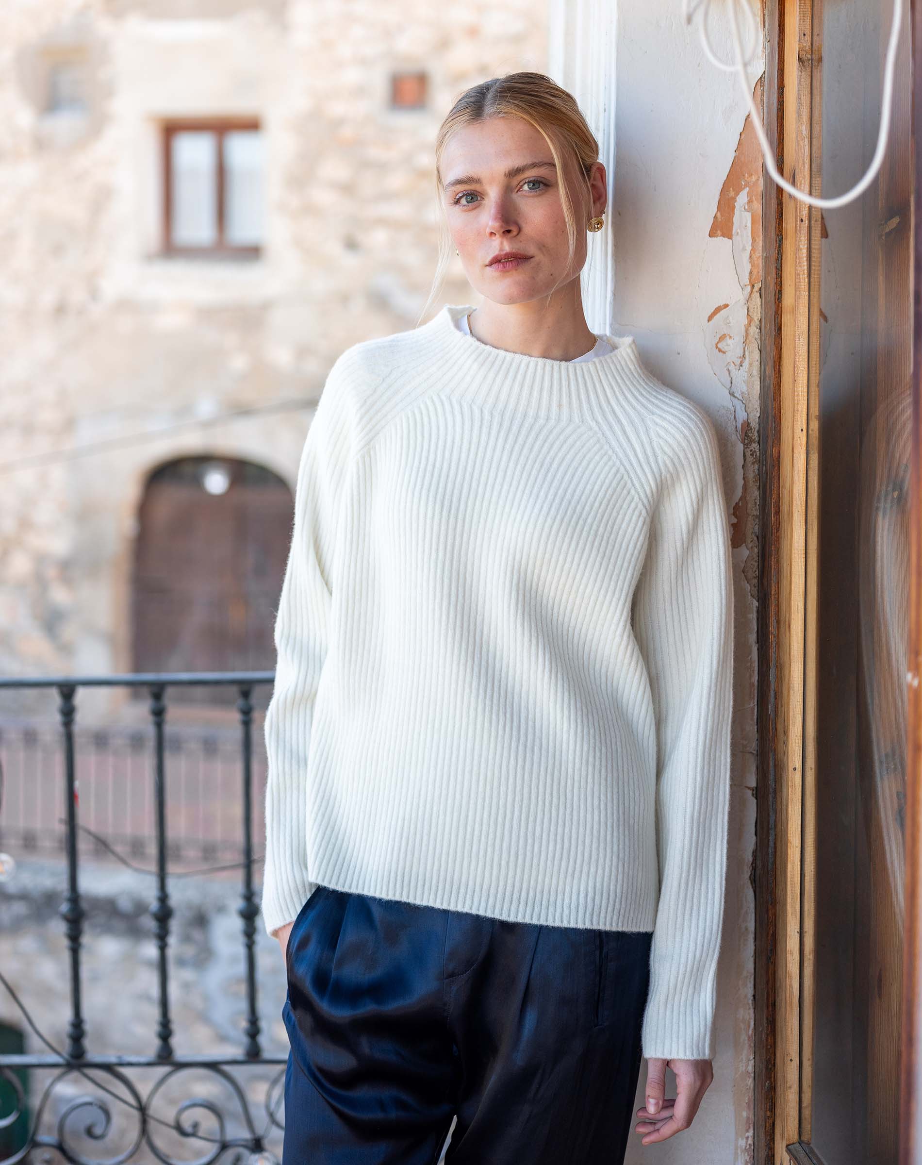 Winter white ribbed knit sweater with long sleeves and a crew neck.