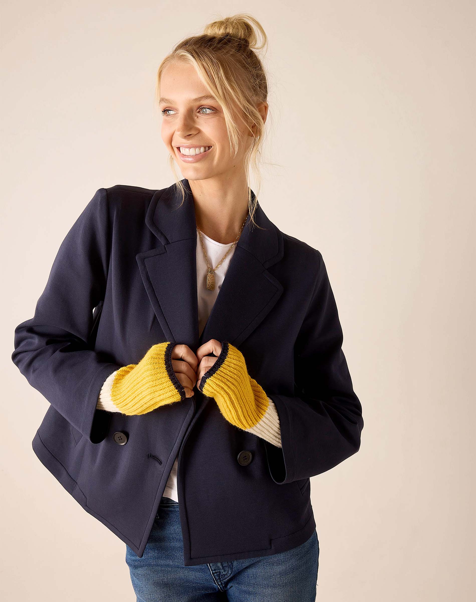 Ladies' travel-ready golden yellow knit fingerless gloves with ribbed texture.