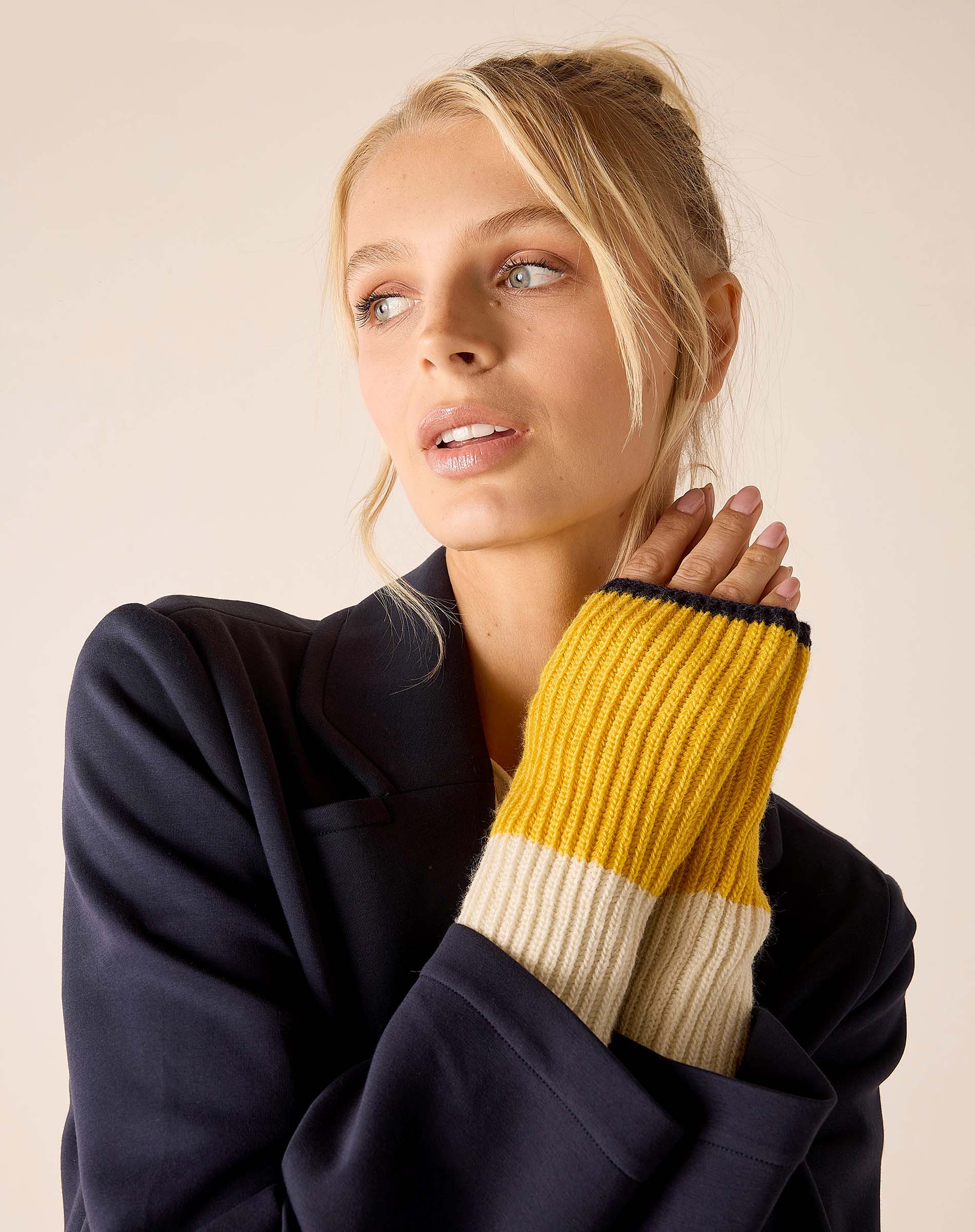 Cream and golden ribbed knit fingerless gloves.