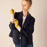 Cream and golden yellow knit fingerless gloves with ribbed cuffs.