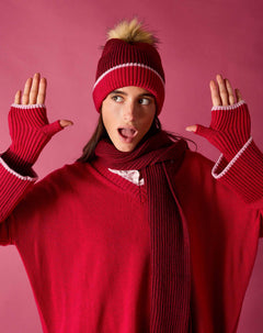 Ladies' travel-ready raspberry pink ribbed knit fingerless gloves featuring white decorative stitching.
