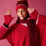Raspberry pink knit fingerless gloves with white and maroon stripe detail.