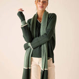 Forest green and cream striped ribbed knit scarf draped over a sweater.