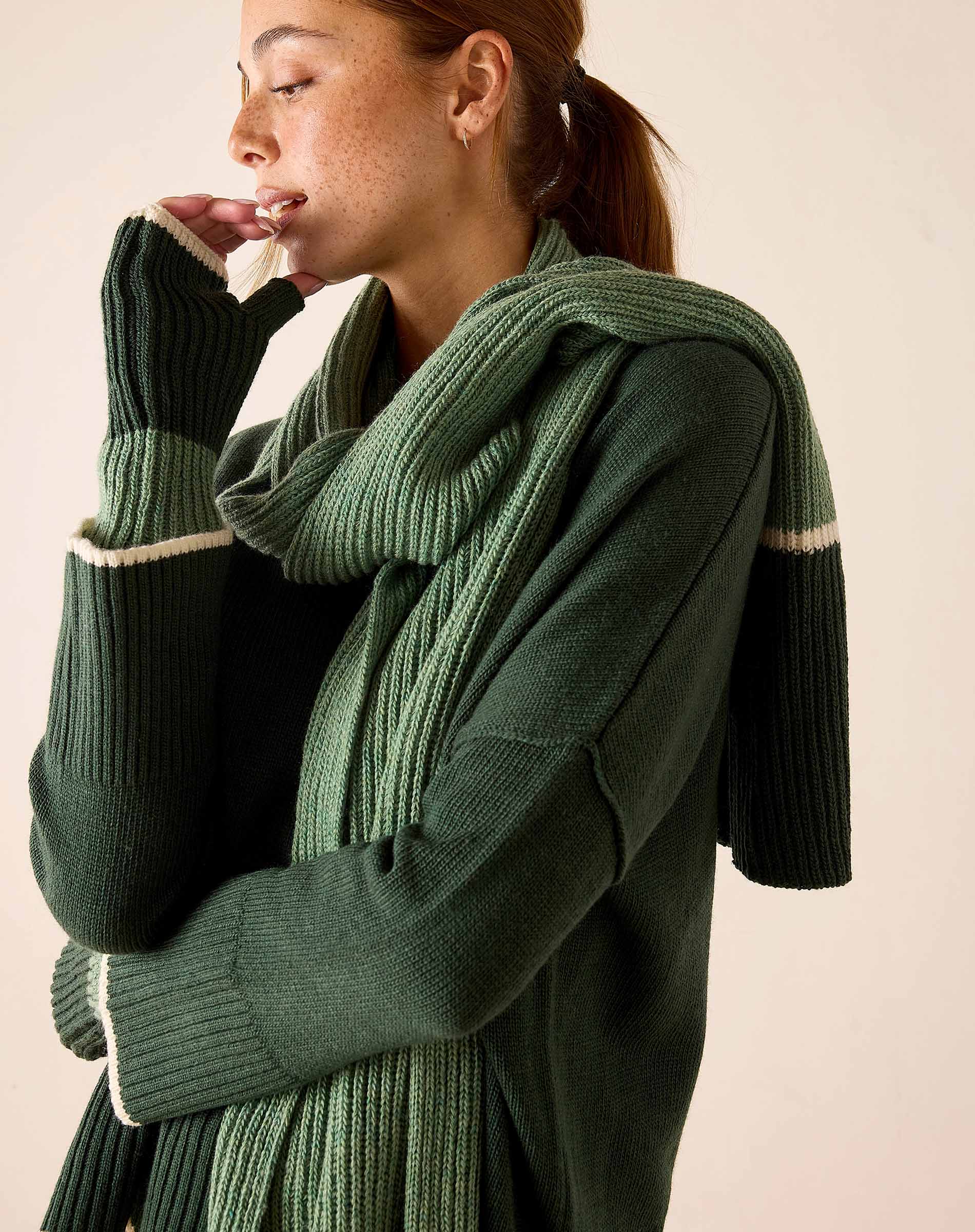 Forest green ribbed knit scarf and matching sweater featuring a white stripe detail.