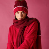 Ladies' travel-ready raspberry pink chunky knit scarf and matching beanie with a pom-pom.