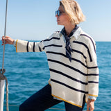 Cream and navy striped knit top with a yellow trim and long sleeves.